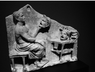 Relief with Menander and New Comedy Masks (Roman, 40–60 CE), part of the Getty Villa collection in Los Angeles. The masks show three of his canonical New Comedy characters: youth, false maiden, and old man.