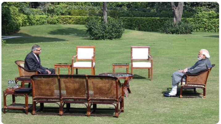 A photo shows a distant view of an interview with the Prime Minister Mr. Narendra Modi in a lawn.